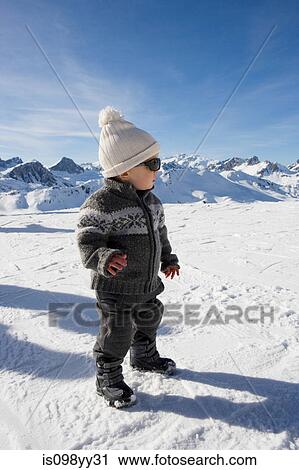 Portrait of boy standing in snow View Large Photo Image Stock Image - Portrait of boy standing in snow. Fotosearch
