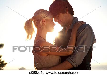 Stock Photograph - Romantic couple at sunset. Fotosearch