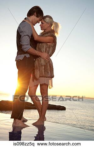 Romantic couple by the ocean at sunset View Large Photo Image Stock Photography - Romantic couple by the ocean at sunset. Fotosearch