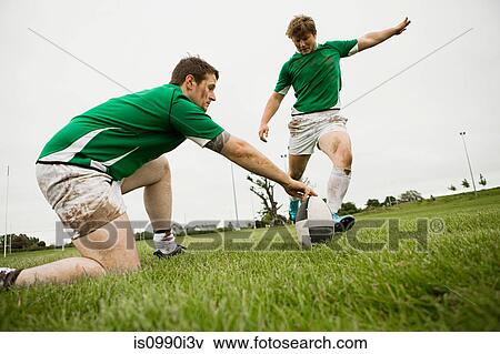 Rugby player kicking ball View Large Photo Image Stock Photo - Rugby player kicking ball. Fotosearch