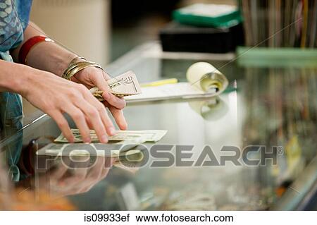 Shop keeper counting money in shop View Large Photo Image Stock Image - Shop keeper counting money in shop. Fotosearch