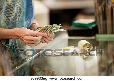 Shop keeper counting money in shop View Large Photo Image Stock Image - Shop keeper counting money in shop. Fotosearch