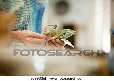 Shop keeper counting money in shop View Large Photo Image Stock Image - Shop keeper counting money in shop. Fotosearch