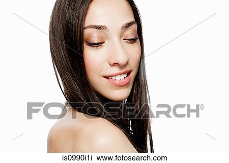 Stock Image - Woman looking down, portrait. Fotosearch