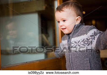Young boy in chalet doorway View Large Photo Image Stock Photo - Young boy in chalet doorway. Fotosearch