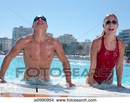 Young couple exiting swimming pool View Large Photo Image Picture - Young couple exiting swimming pool. Fotosearch