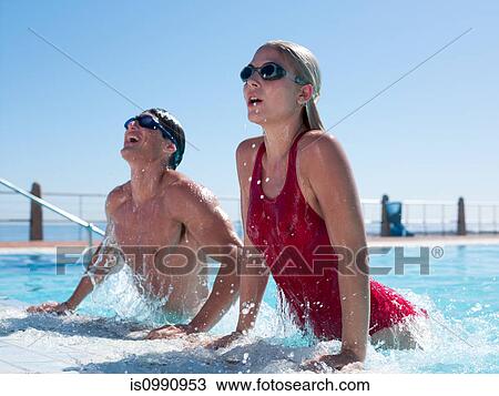 Young couple exiting swimming pool View Large Photo Image Stock Image - Young couple exiting swimming pool. Fotosearch