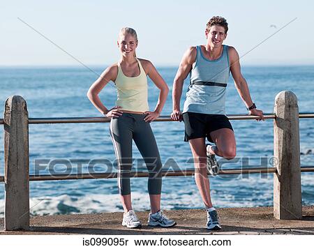 Young couple in sportswear resting, portrait View Large Photo Image Stock Photography - Young couple in sportswear resting, portrait. Fotosearch
