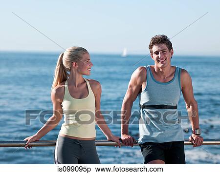 Young couple resting on railings View Large Photo Image Stock Photography - Young couple resting on railings. Fotosearch