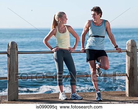 Young couple resting on railings View Large Photo Image Stock Photography - Young couple resting on railings. Fotosearch