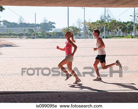 Young couple running View Large Photo Image Stock Image - Young couple running. Fotosearch