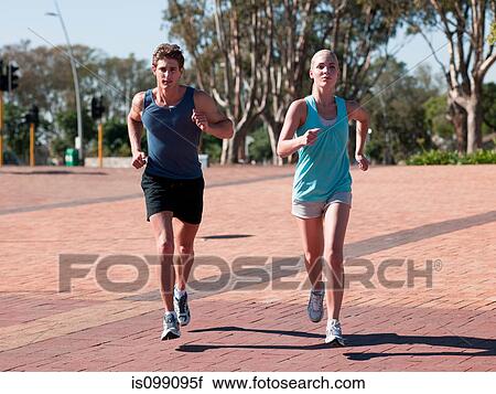Stock Image - Young couple running. Fotosearch