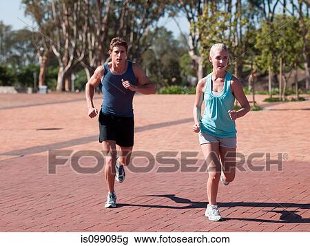 Young couple running View Large Photo Image Stock Image - Young couple running. Fotosearch