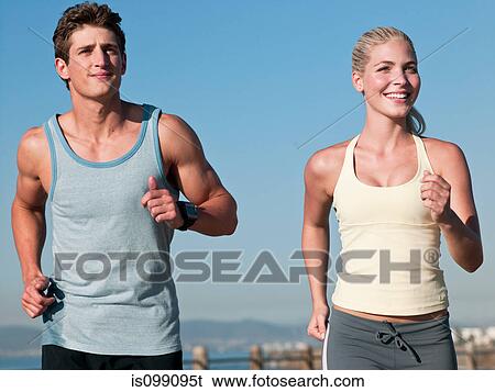 Stock Photograph - Young couple running. Fotosearch