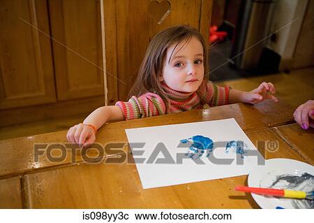 Stock Image - Young girl finger painting. Fotosearch