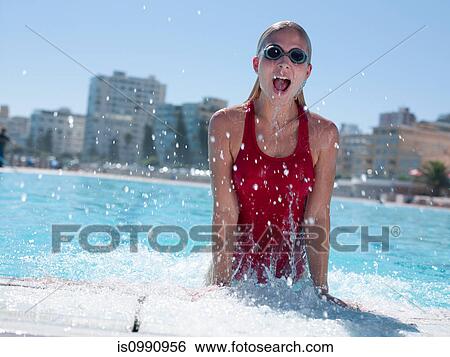 Stock Photograph - Young woman exiting swimming pool. Fotosearch