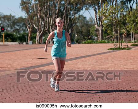 Stock Image - Young woman running. Fotosearch