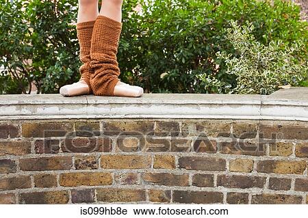 Ballerina standing on wall, low section View Large Photo Image Stock Image - Ballerina standing on wall, low section. Fotosearch