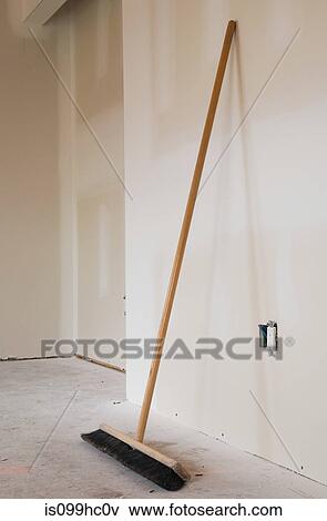 Broom leaning against a wall View Large Photo Image Stock Photo - Broom leaning against a wall. Fotosearch