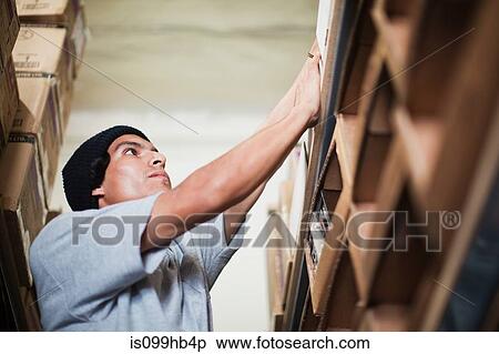 Man working in stockroom View Large Photo Image Stock Photography - Man working in stockroom. Fotosearch