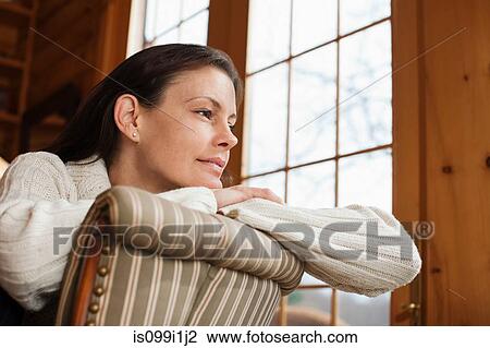 Mature woman relaxing in armchair View Large Photo Image Stock Image - Mature woman relaxing in armchair. Fotosearch