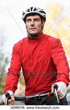 Mid adult man cycling View Large Photo Image Stock Image - Mid adult man cycling. Fotosearch
