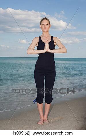 Mid adult woman in yoga pose on beach View Large Photo Image Stock Image - Mid adult woman in yoga pose on beach. Fotosearch