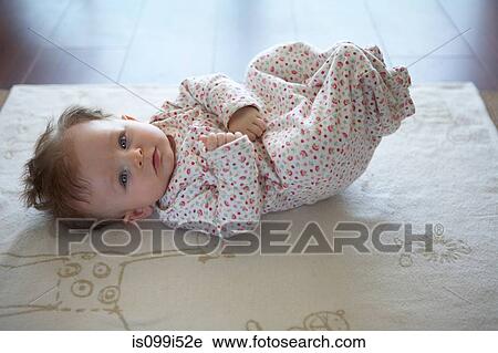 Portrait of baby girl lying on back View Large Photo Image Stock Image - Portrait of baby girl lying on back. Fotosearch