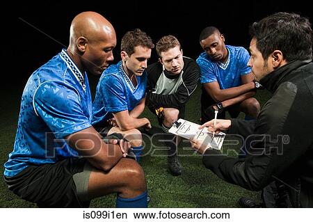 Picture - Soccer team planning game with coach. Fotosearch