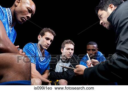 Picture - Soccer team planning game with coach. Fotosearch