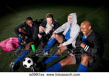 Soccer team resting on pitch after game View Large Photo Image Stock Photograph - Soccer team resting on pitch after game. Fotosearch