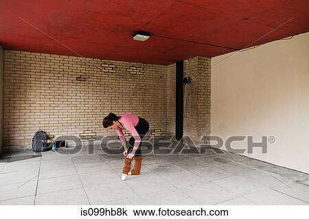 Woman adjusting leg warmers before work out View Large Photo Image Stock Image - Woman adjusting leg warmers before work out. Fotosearch