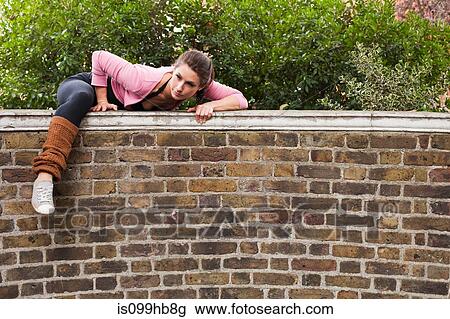Woman climbing over over wall View Large Photo Image Stock Image - Woman climbing over over wall. Fotosearch