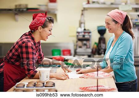 Women working together in commercial kitchen View Large Photo Image Stock Image - Women working together in commercial kitchen. Fotosearch