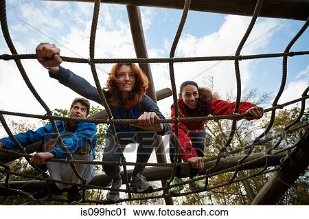 Young friends climbing assault course equipment View Large Photo Image Stock Image - Young friends climbing assault course equipment. Fotosearch