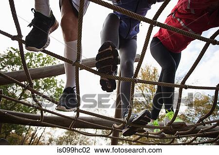 Young friends climbing assault course equipment View Large Photo Image Stock Image - Young friends climbing assault course equipment. Fotosearch