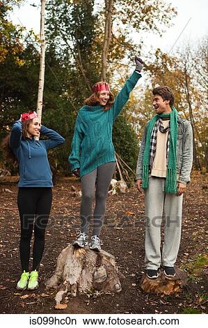 Young friends in forest celebrating success View Large Photo Image Picture - Young friends in forest celebrating success. Fotosearch