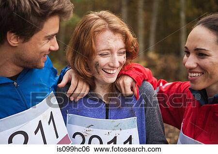 Stock Photograph - Young friends in sportswear smiling. Fotosearch