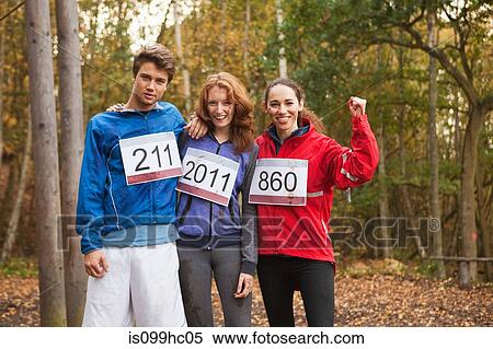 Stock Photography - Young friends in sportswear smiling, portrait. Fotosearch