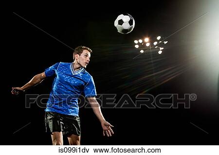Young man leaping to head soccer ball View Large Photo Image Stock Photo - Young man leaping to head soccer ball. Fotosearch