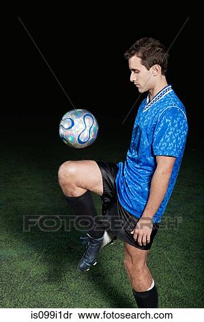 Young man with soccer ball on pitch View Large Photo Image Stock Photography - Young man with soccer ball on pitch. Fotosearch