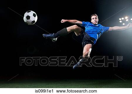 Young soccer player leaping into air to kick ball View Large Photo Image Stock Image - Young soccer player leaping into air to kick ball. Fotosearch