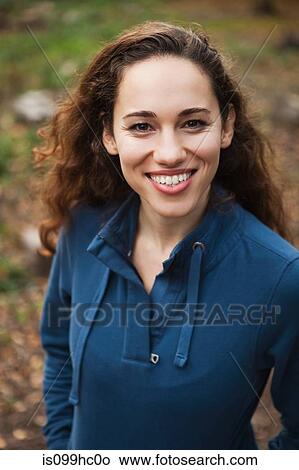 Young woman in forest smiling, portrait View Large Photo Image Picture - Young woman in forest smiling, portrait. Fotosearch