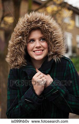 Young woman in furry hood smiling View Large Photo Image Stock Photo - Young woman in furry hood smiling. Fotosearch