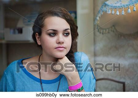 Stock Photo - Young woman in looking away. Fotosearch