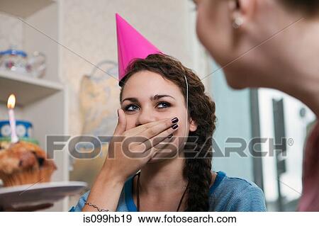 Stock Photo - Young woman wearing party hat. Fotosearch