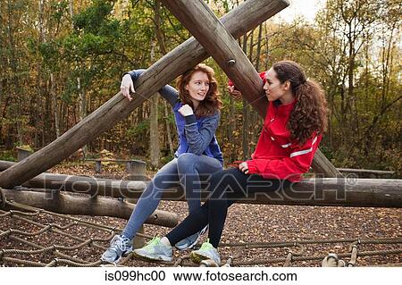 Young women sitting on assault course equipment View Large Photo Image Stock Image - Young women sitting on assault course equipment. Fotosearch