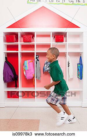 Stock Image - Boy running in school. Fotosearch