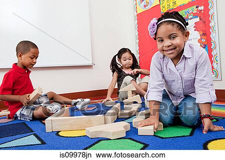 Children on floor with building blocks View Large Photo Image Picture - Children on floor with building blocks. Fotosearch