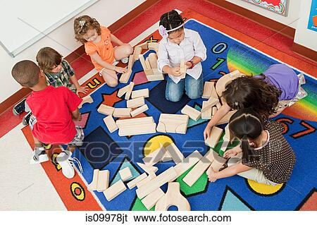 Children playing with building blocks View Large Photo Image Stock Photograph - Children playing with building blocks. Fotosearch